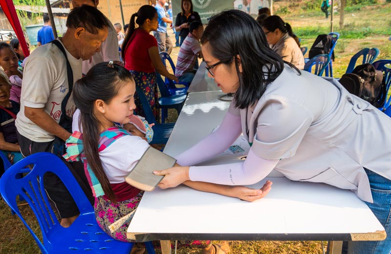 Nurse taking blood pressure of child